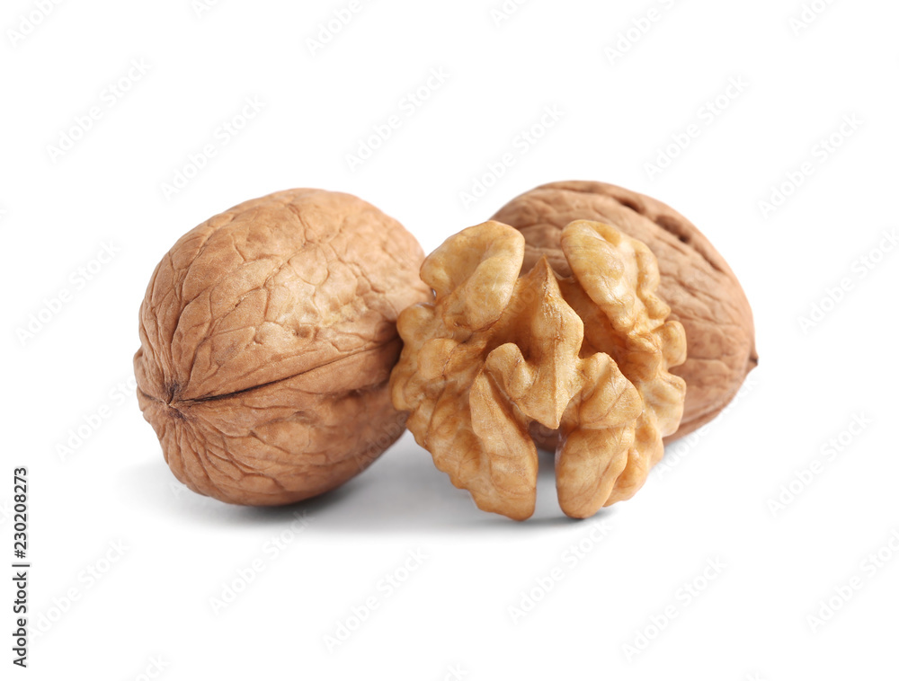 half of walnut kernels and whole nuts isolated on white background half of walnut kernels and whole nuts isolated on white background