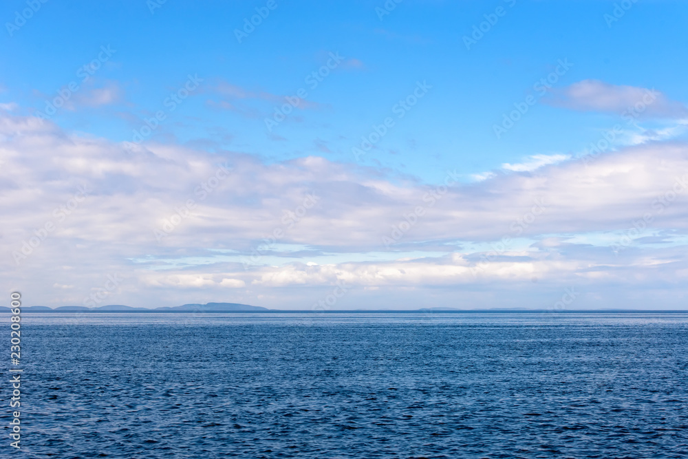 Summer afternoon view from the sea to the islands of the Body (Kuzova archipelago) in the White Sea
