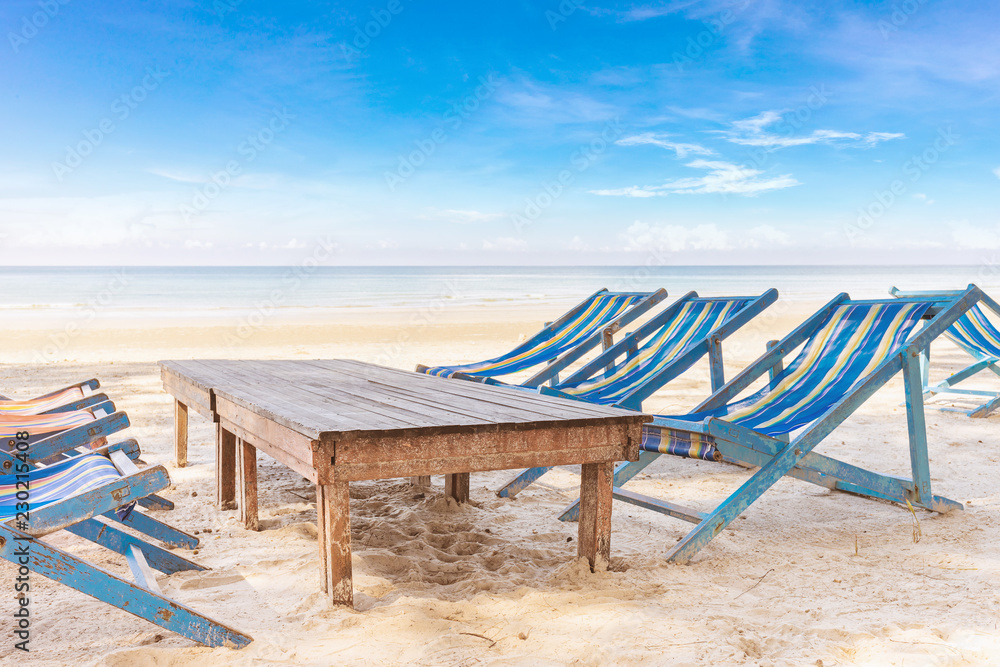 Deckchairs or Liegestuhl on the Beach with bright blue sky