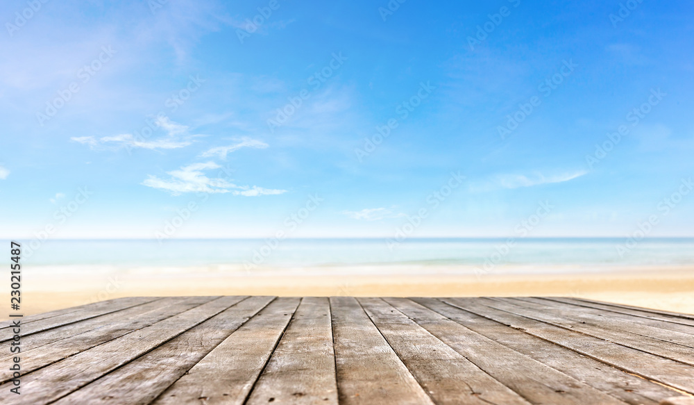wooden table top or wooden plank in front of the beach background