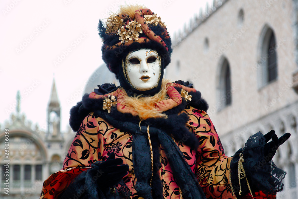 Carnival black-gold mask and costume at the traditional festival in Venice, Italy