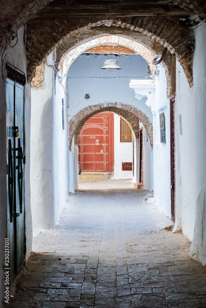 Naklejka premium Narrow medieval street in the white medina of the Tetouan city, Morocco in Africa