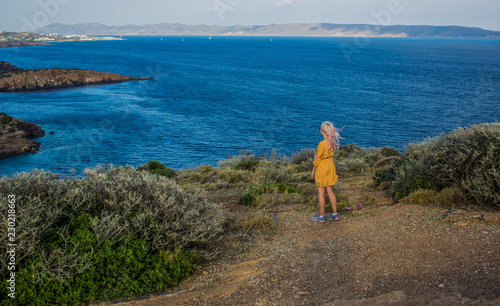 female travel nature scenery landscape concept of lady in yellow dress stay on edge of mountain top above south sea in summer bright weather with little wind on cape