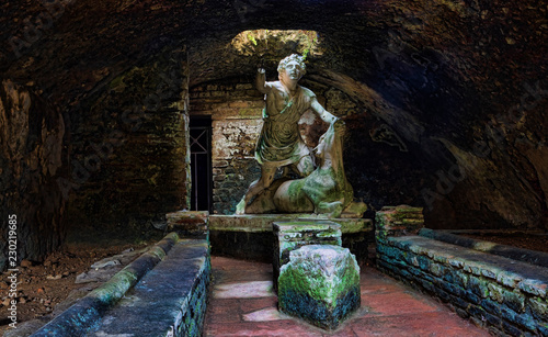 Photography Statue of the god Mithras killing a bull in the thermal s mithraeum in archaeolo