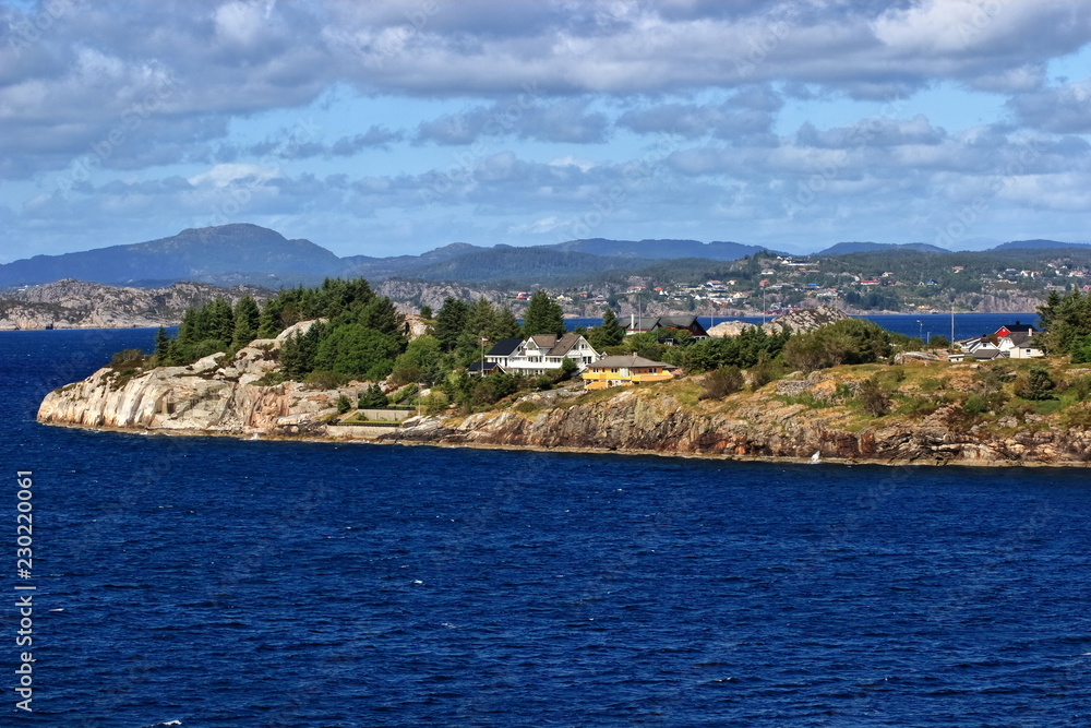 A color image of the scenic Norwegian coastline as seen from the balcony of a cruise ship.
