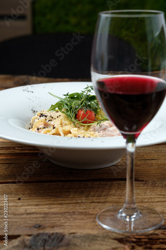 Glass of red wine and cheese pasta