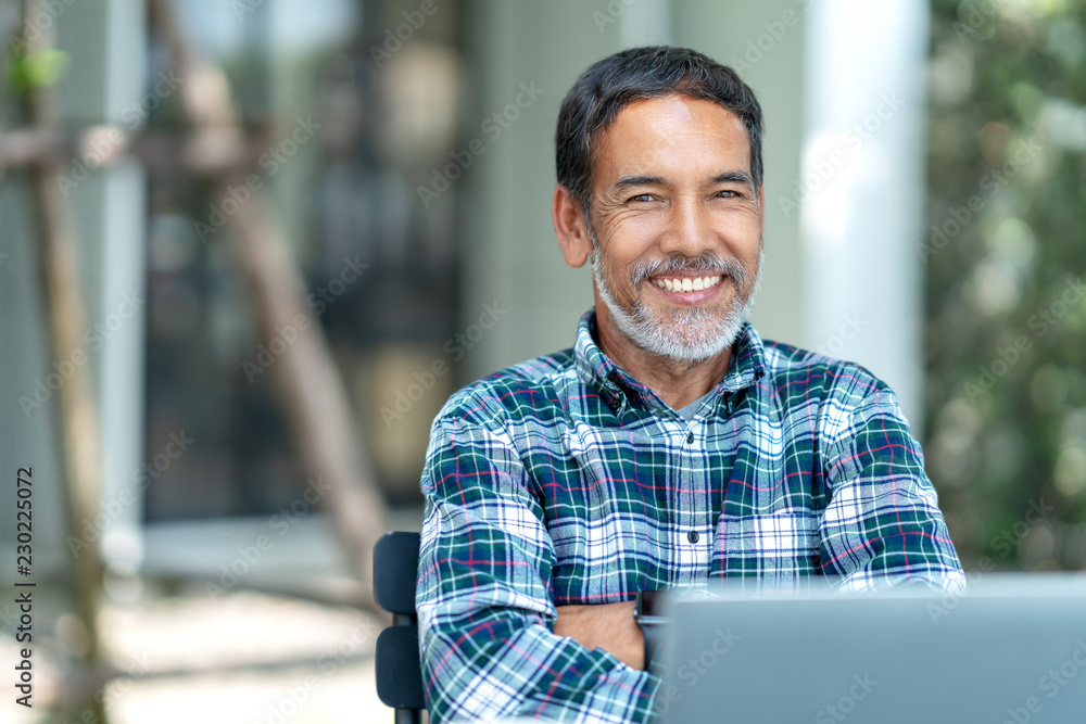 Portrait of happy mature man with white, grey stylish short beard looking at camera outdoor. Casual lifestyle of retired hispanic people or adult asian man smile with confident at coffee shop cafe. - obrazy, fototapety, plakaty 