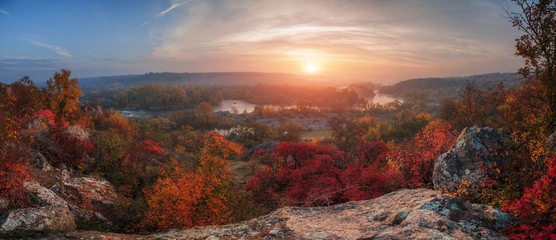 amazing panoramic  view of  blue foggy river and colorful forest on sunrise. autumn landscape