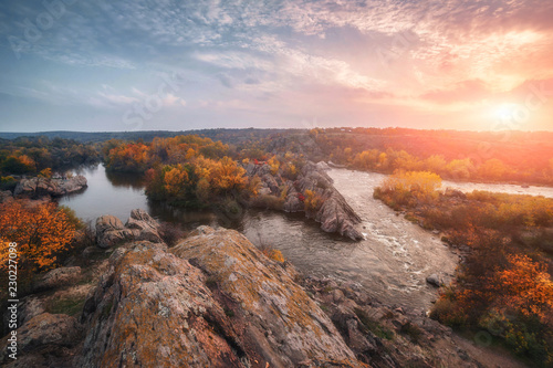 amazing aerial view of mountain rocks,  foggy river and colorful forest on sunrise. autumn landscape