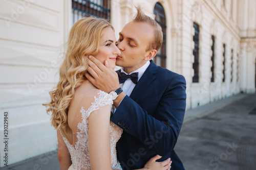 Wife with her husband walking by the palace. they spend time togeter