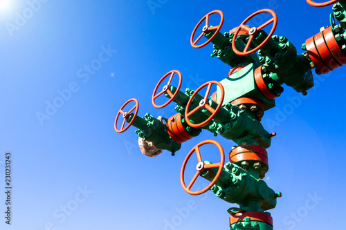 Oil and gas processing plant with pipe line valves. Oil pipeline valves in the oil and gas industry. Valve plug an oil pipeline in the field on a sunny summer day