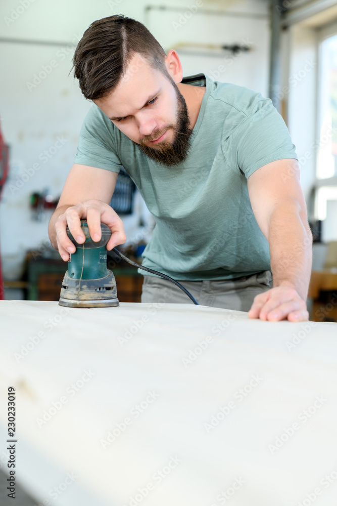 young worker in a carpenter's workshop