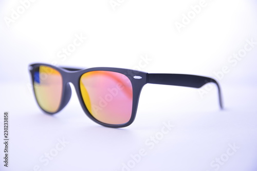 Black-rimmed sunglasses with rainbow glasses on a white background isolated