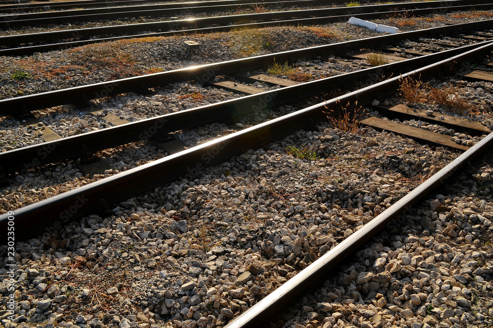 Railway, rails and sleepers on a bright sunny day close up. Rails for railway transport are made of carbon steel Railway, rails and sleepers on a bright sunny day close up. Rails for railway transport are made of carbon steel