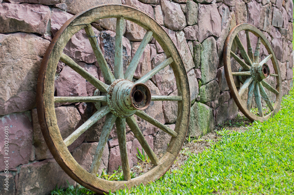 wagon wheels on purple stone wall