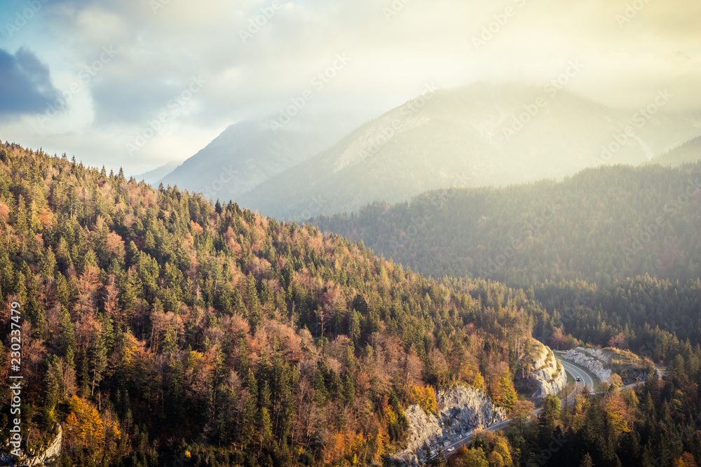 Curvy road in the European Alps in Austria in autumn colors, nature background concept