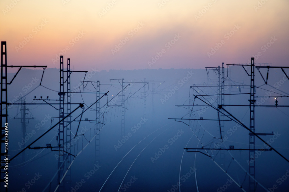 railways & electricity pylons at sunset, industrial landscape
