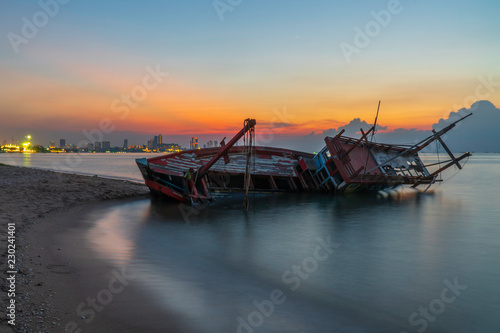 Shipwreck on the beach at sunset © Sunday Stock