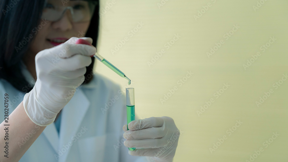 Asian woman scientists are testing different chemicals in the lab Asian woman scientists are testing different chemicals in the lab