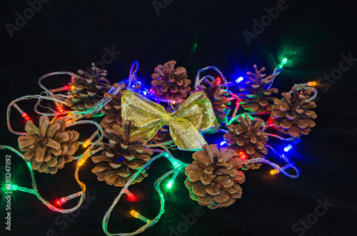 Christmas tree garland, pine cone, Christmas tree, butterfly, candle.