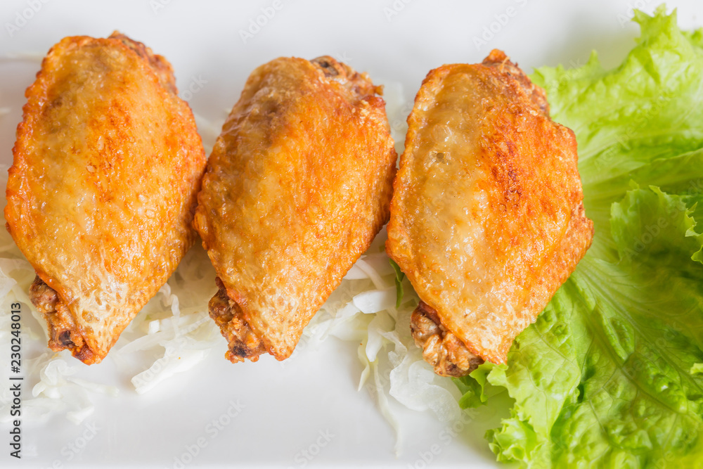 Closeup of Fried chicken wings in white dish Closeup of Fried chicken wings in white dish
