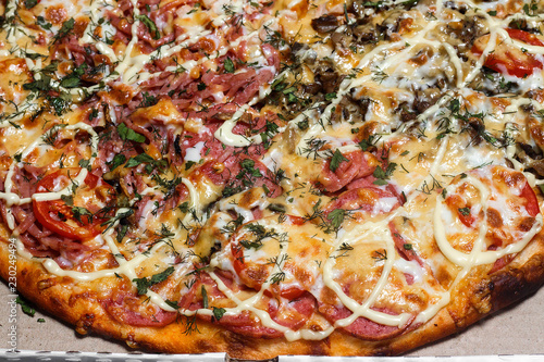 Pizza in a cardboard box. Close up. Pizza delivery. Pizza menu
