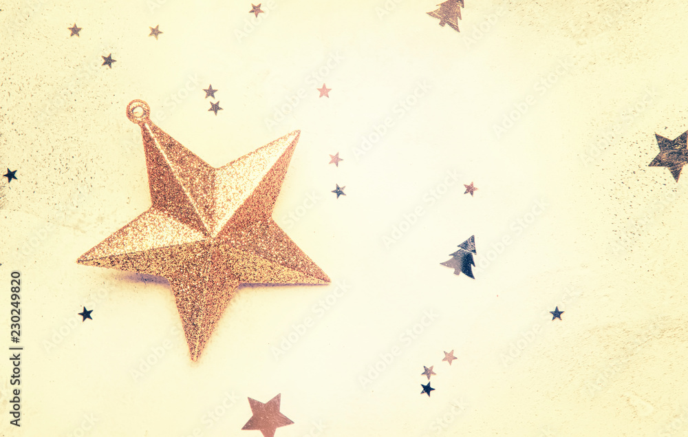 Christmas or New Year composition, frame, pink background with gold Christmas decorations, stars, snowflakes, balls, alarm clock, gift box and bottle of champagne, top view Christmas or New Year composition, frame, pink background with gold Christmas decorations, stars, snowflakes, balls, alarm clock, gift box and bottle of champagne, top view