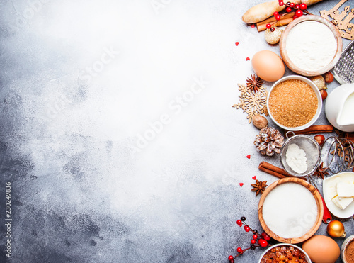 Christmas or New Year composition with ingredients for baking or cookies, with golden snowflakes, Christmas balls, on gray background, with inscription merry xmas, frame, top view
