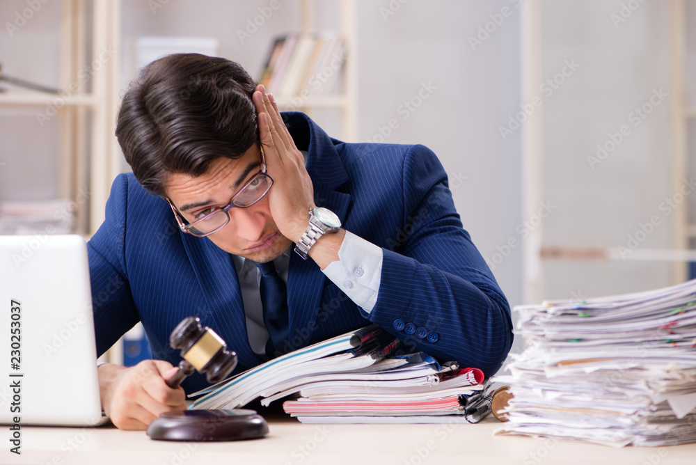 Naklejka premium Young handsome judge working in court