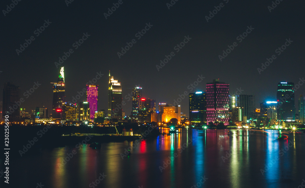 Fototapeta premium Buildings along Saigon river (Vietnam) in sunset
