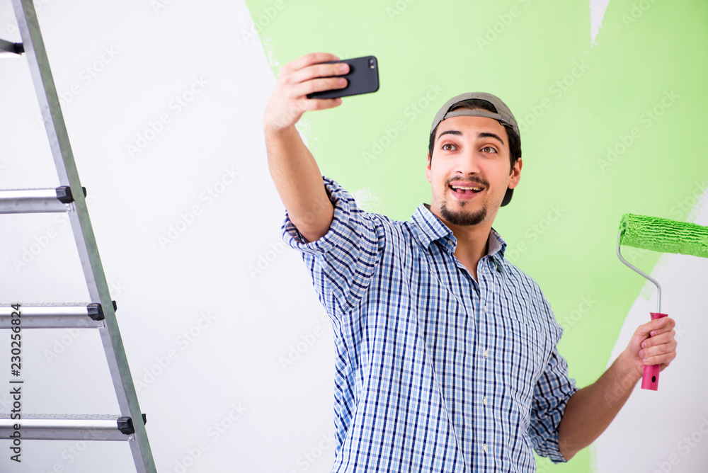 Young painter doing renovation at home Young painter doing renovation at home