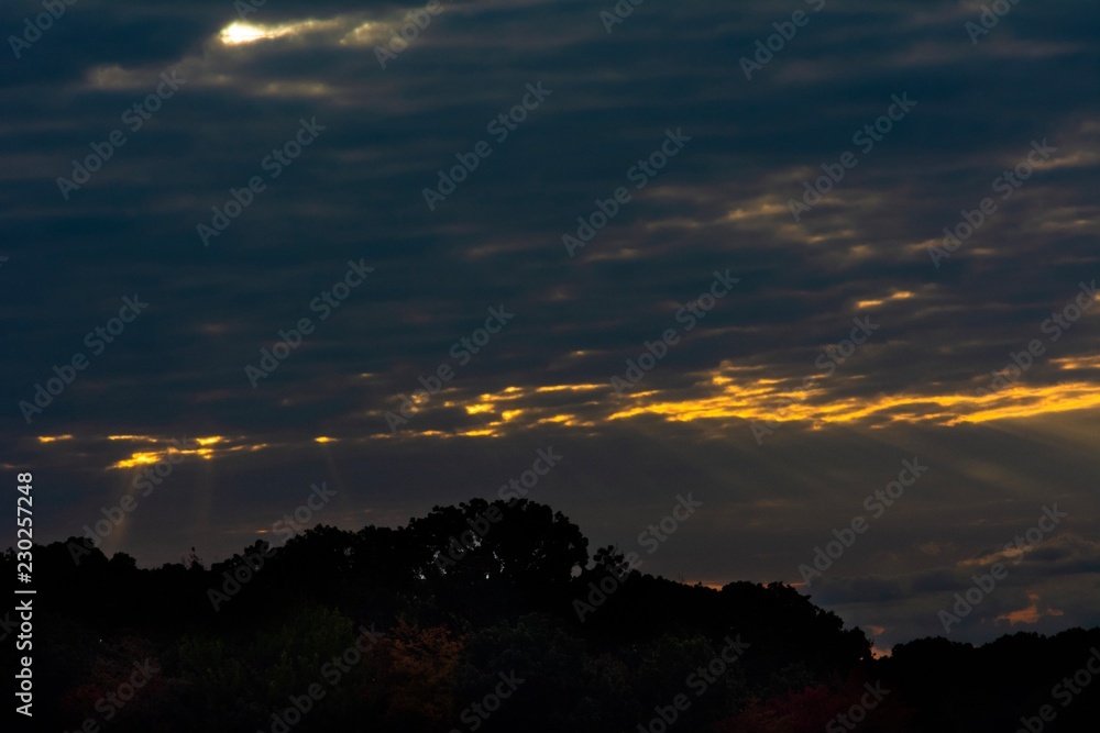 Light peeking through clouds sunrise