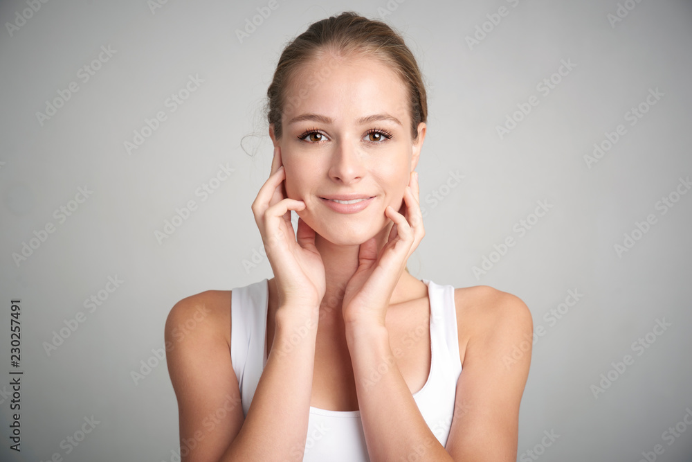 Young woman with beautiful face. Studio portrait. Young woman with beautiful face. Studio portrait.