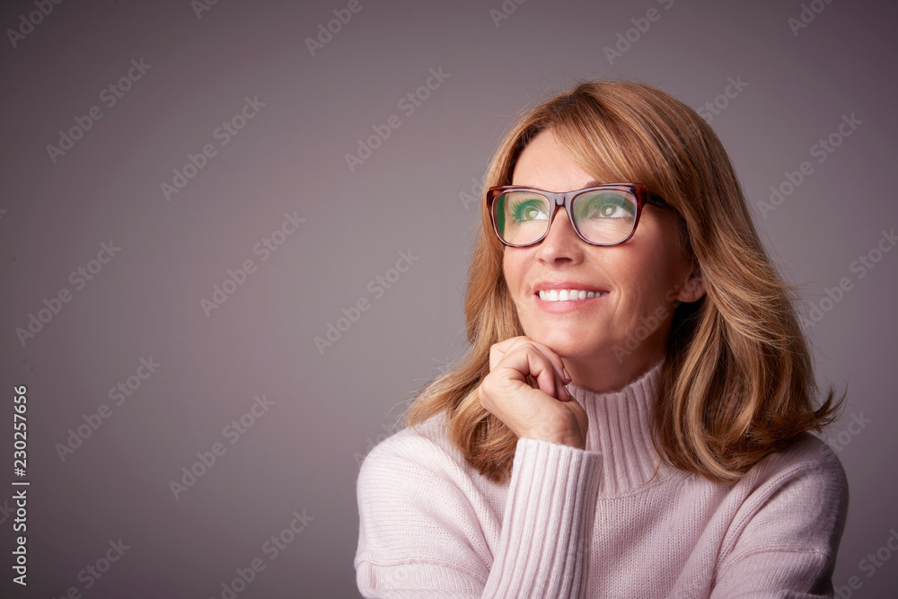 Close-up studio portrait of attractive middle aged woman