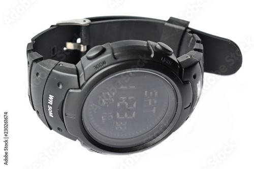 Men's electronic modern quartz sport black wrist watch with buttoned rubber strap on white background. Isolated. Dial view
