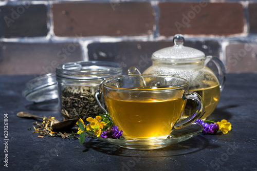 cup of tea with aromatic herbs on a dark background