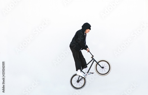 Schilderij op canvas Bmx rider jumping with a bicycle on a white background