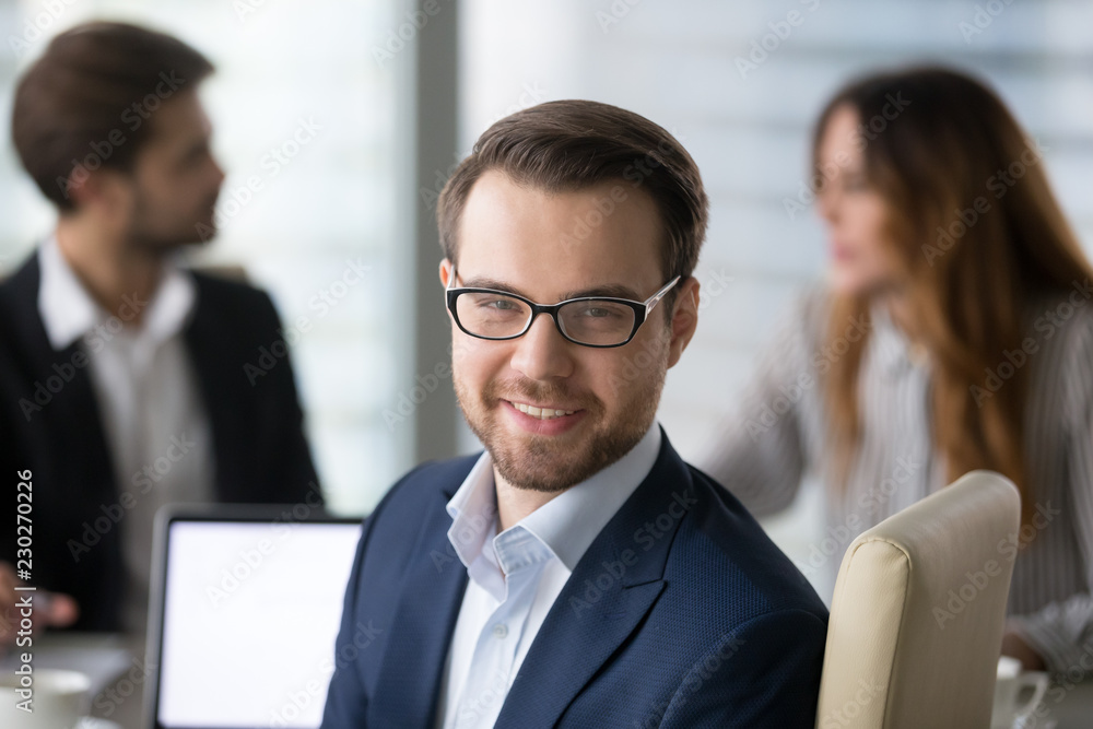 Φωτογραφία Head shot portrait of confident businessman or business owner at workplace, smiling man sitting at briefing and looking at camera