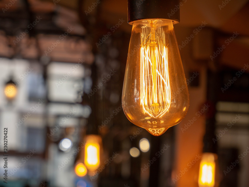 Classic light bulbs in a dark environment emitting warm orange light	
