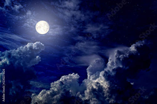 Full moon and stars in cumulus clouds