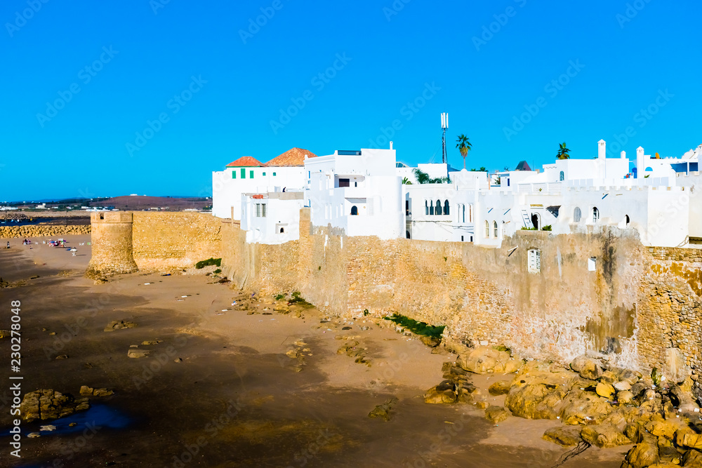 Ancient city wall of white medina of the town Asilah at ocean coast, Morocco in Africa