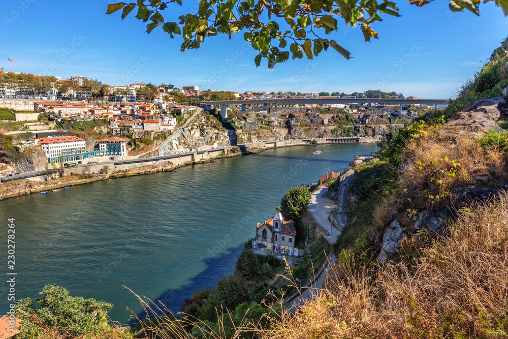 Fototapeta premium The Douro River through the Portuguese city of Porto. Capela Alem.