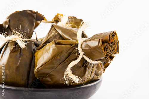 Traditional Colombian tamale as made on Tolima region isolated on white background photo