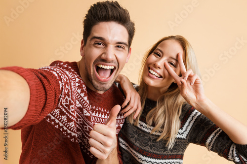Portrait of an excited young couple dressed in sweaters
