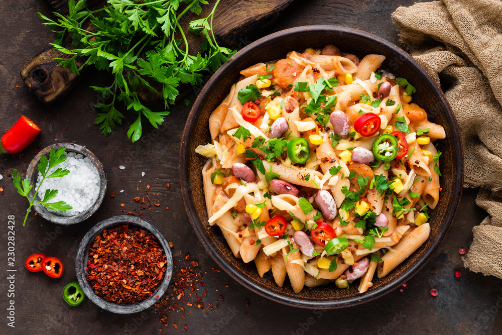 Spicy pasta penne bolognese with vegetables, beans, chili and cheese in tomato sauce Spicy pasta penne bolognese with vegetables, beans, chili and cheese in tomato sauce