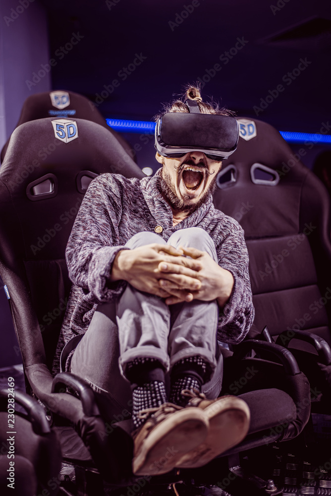 man in virtual glasses is watching a movie in 5d in a cinema