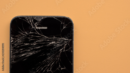 broken phone on a orange pastel background