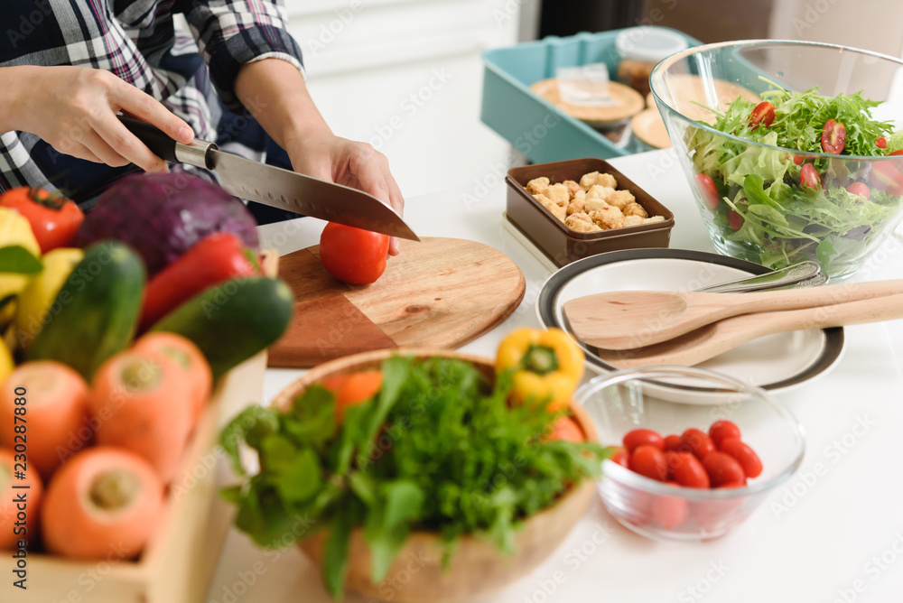 Healthy Young beautiful asian woman preparing vegetable for salad in kitchen Healthy Young beautiful asian woman preparing vegetable for salad in kitchen