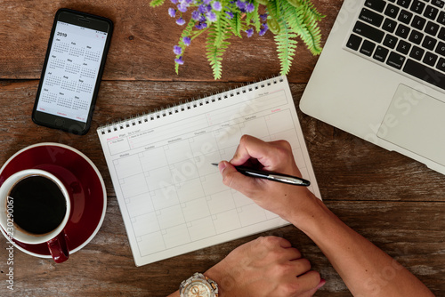 Fotografi SEPTEMBER 17, 2018: Working table top with organizer for monthly planing with Ip