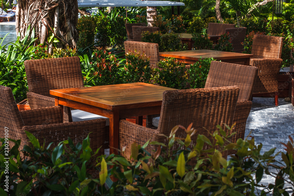 Fototapeta premium Sunny outdoor terrace with rattan furnitures